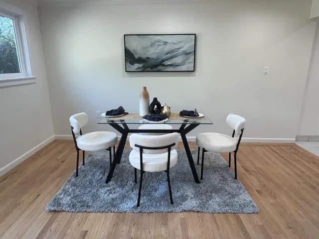 a dining room with furniture and window