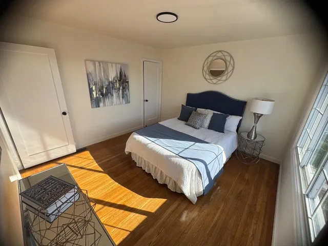 a bedroom with bed and a window