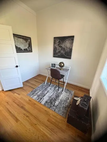 a living room with couch and a rug