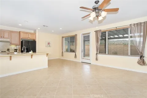 a living room with furniture and view of kitchen