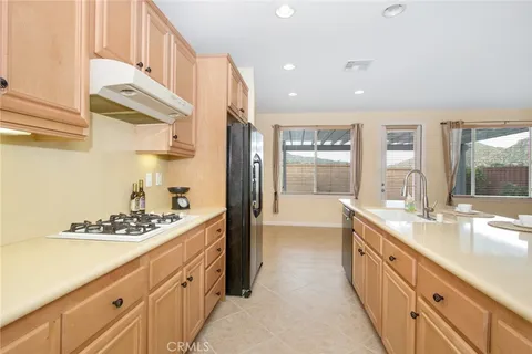 a large white kitchen with cabinets a sink and a stove