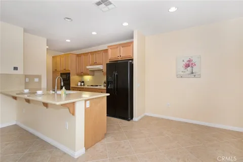 a kitchen with stainless steel appliances kitchen island granite countertop a sink stove and cabinets