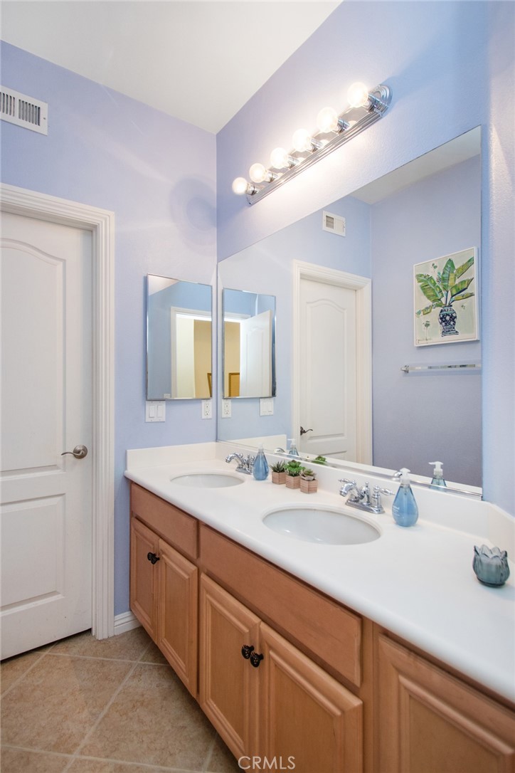 8172 Parry Drive Hemet, CA 92545 - Photo 21 of 41 Hallway bathroom with double vanity