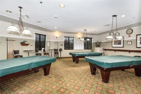 a living room with furniture a rug and kitchen view
