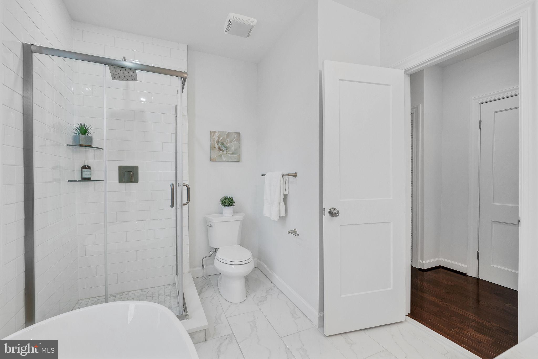 3009 20th Street Northeast Washington, DC 20018 - Photo 16 of 24 a bathroom with a granite countertop toilet a sink and shower