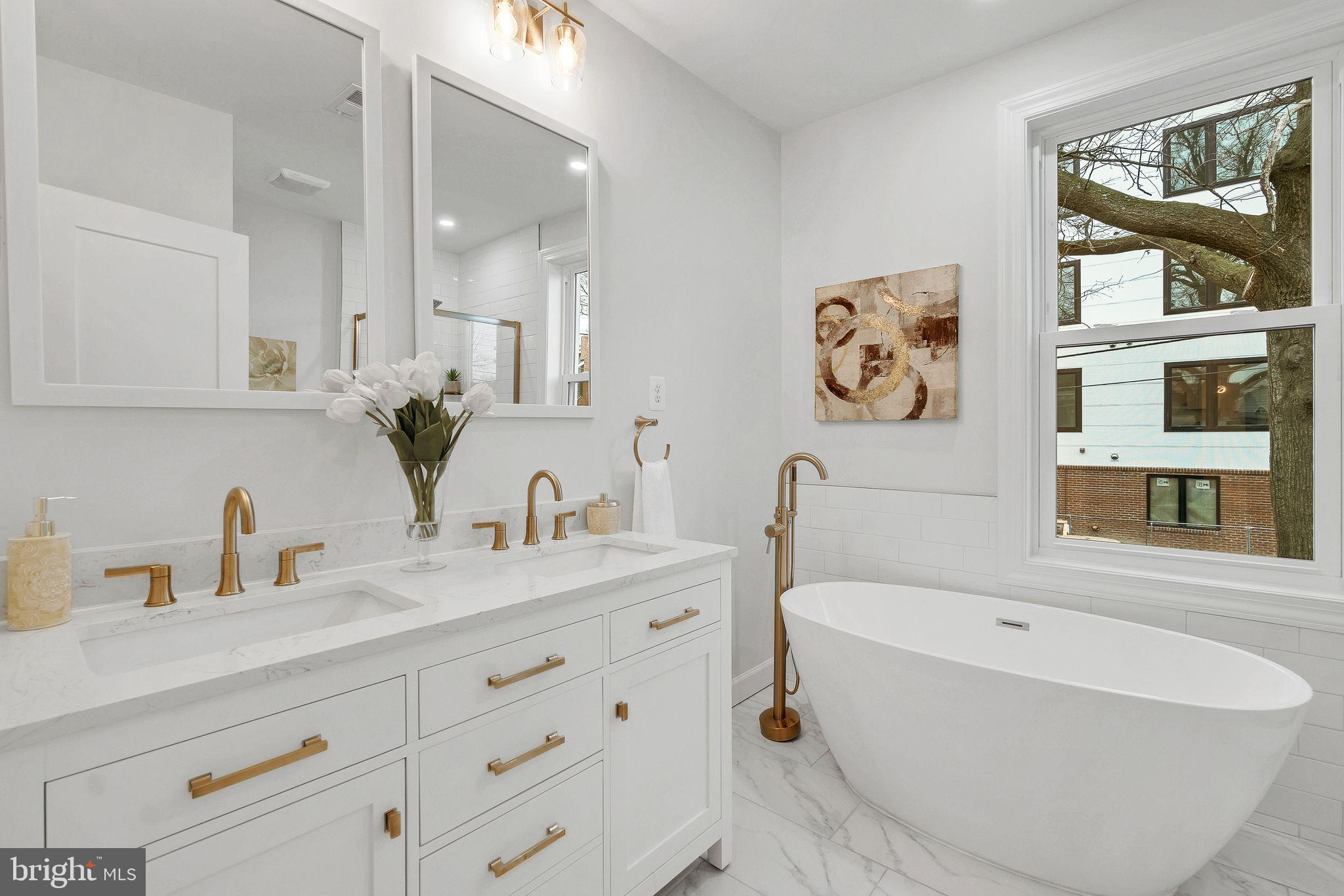3009 20th Street Northeast Washington, DC 20018 - Photo 4 of 24 a bathroom with a tub sink and mirror