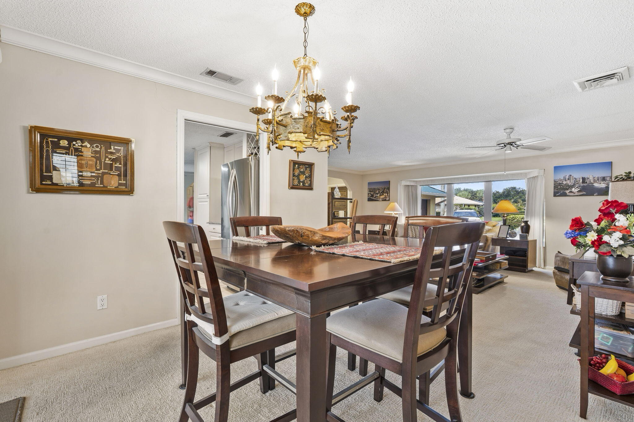 3374 Southeast Fairway East Stuart, FL 34997 - Photo 13 of 65 a view of a dining room and livingroom with furniture a chandelier and a rug