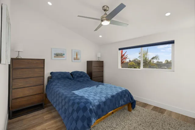 a view of a bedroom with wooden floor and bathroom