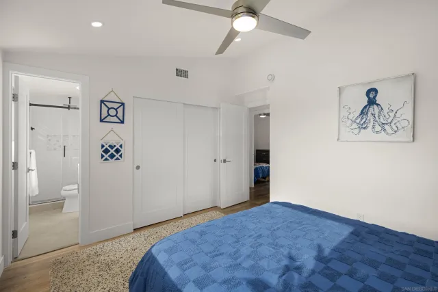 a bathroom with a sink toilet vanity and shower
