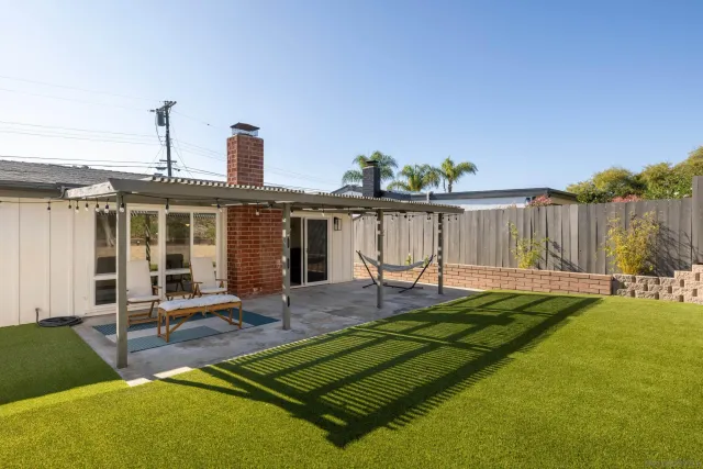 a view of a backyard with chairs