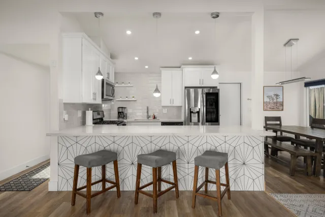 a kitchen with stainless steel appliances a stove a sink and a refrigerator