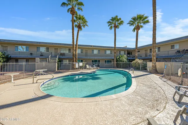 swimming pool view with a garden space