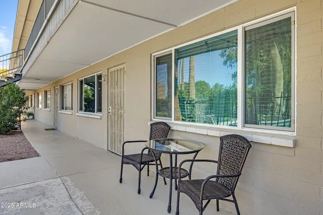 a dining room with furniture and front door