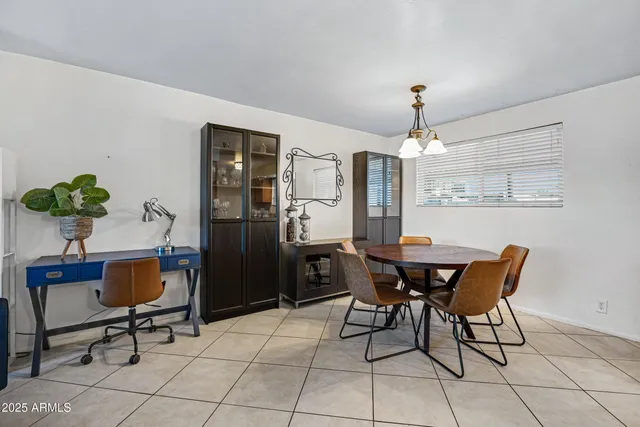 a view of a dining room with furniture and chandelier