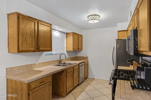 a view of a kitchen with a sink and a refrigerator
