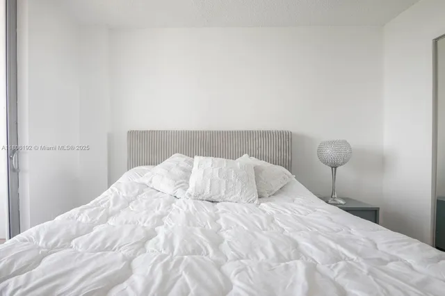 a bedroom with a bed and lamp