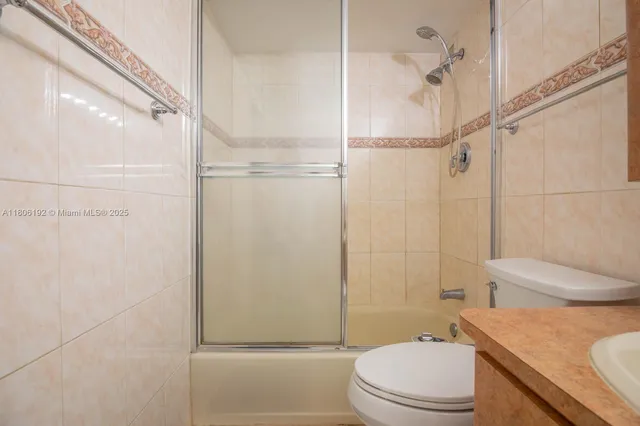 a bathroom with a shower a toilet and a shower