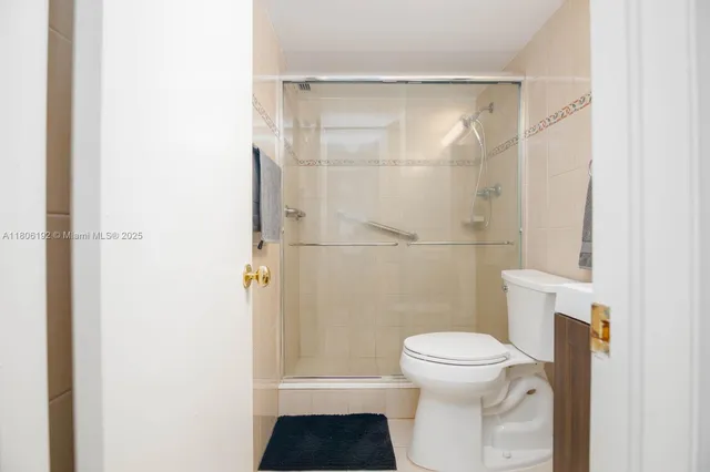 a bathroom with a toilet and a shower