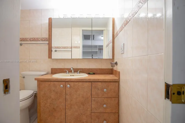 a bathroom with a sink toilet and mirror