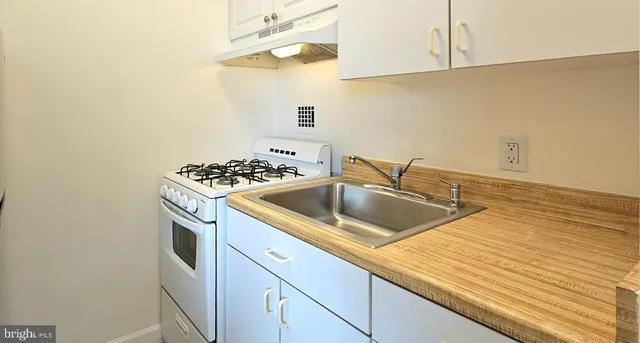 a utility room with dryer washer and stair