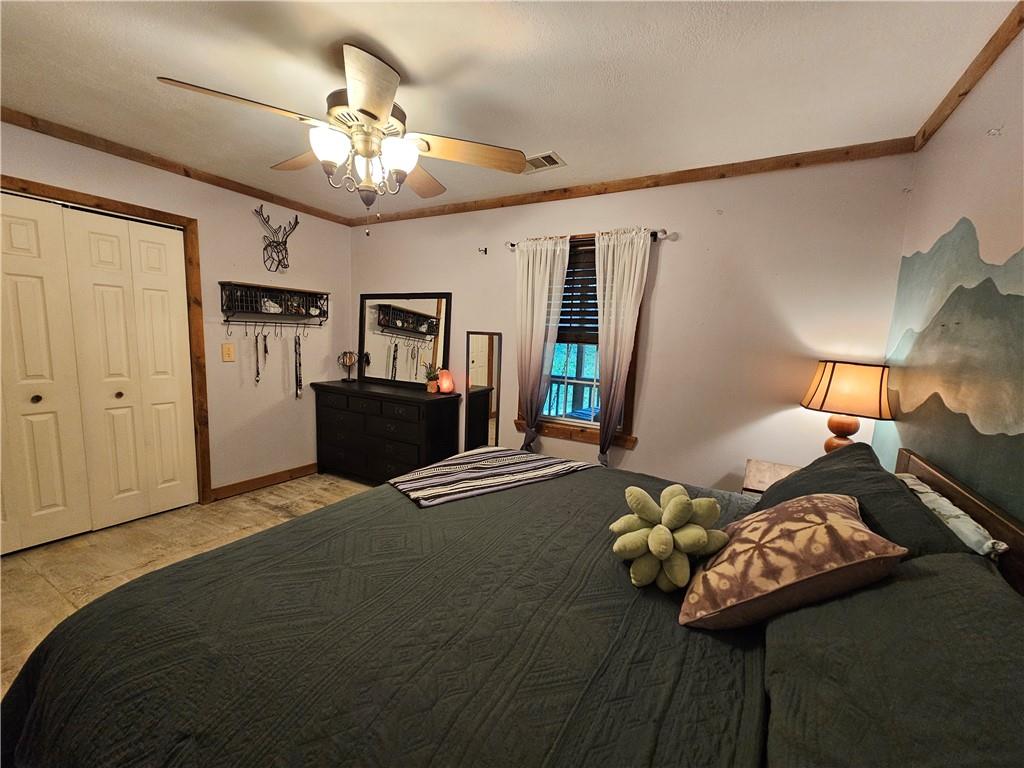 131 Chestatee Spgs Ridge Dahlonega, GA 30533 - Photo 13 of 51 a bedroom with furniture and a chandelier