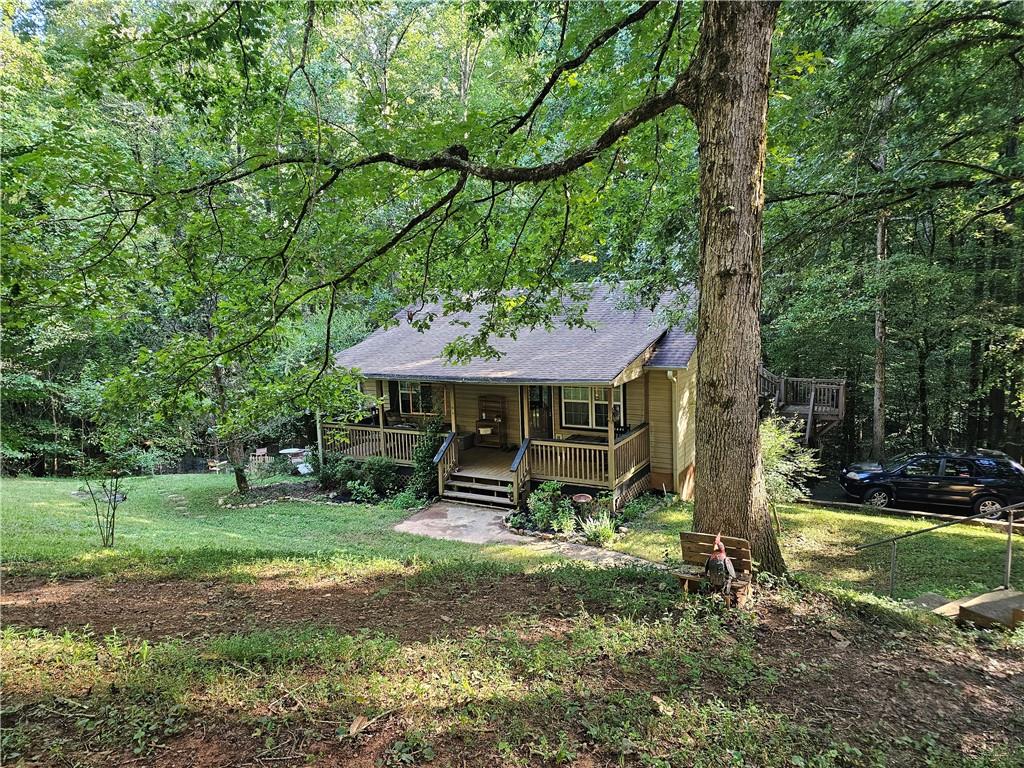 131 Chestatee Spgs Ridge Dahlonega, GA 30533 - Photo 2 of 51 a backyard of a house with barbeque oven table and chairs