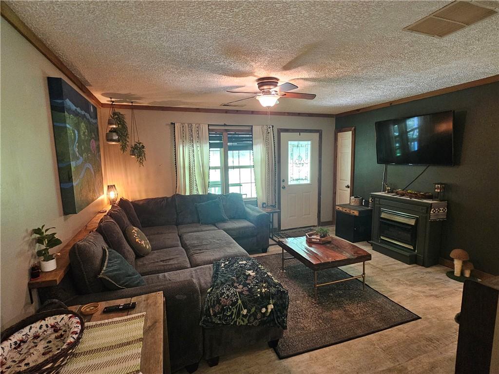 131 Chestatee Spgs Ridge Dahlonega, GA 30533 - Photo 25 of 51 a living room with furniture a flat screen tv and kitchen view