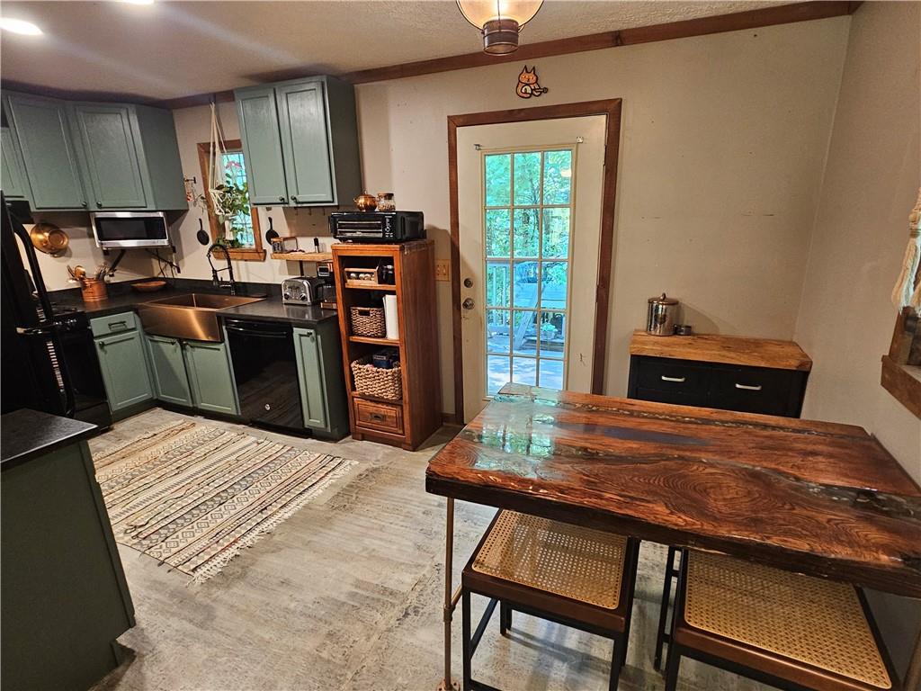 131 Chestatee Spgs Ridge Dahlonega, GA 30533 - Photo 33 of 51 a kitchen with a wooden table and chairs