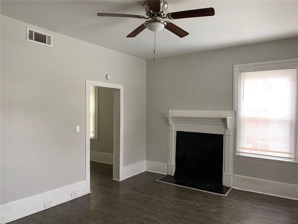 258 Walker Street Augusta, GA 30901 - Photo 7 of 16 a view of an empty room with wooden floor and a window