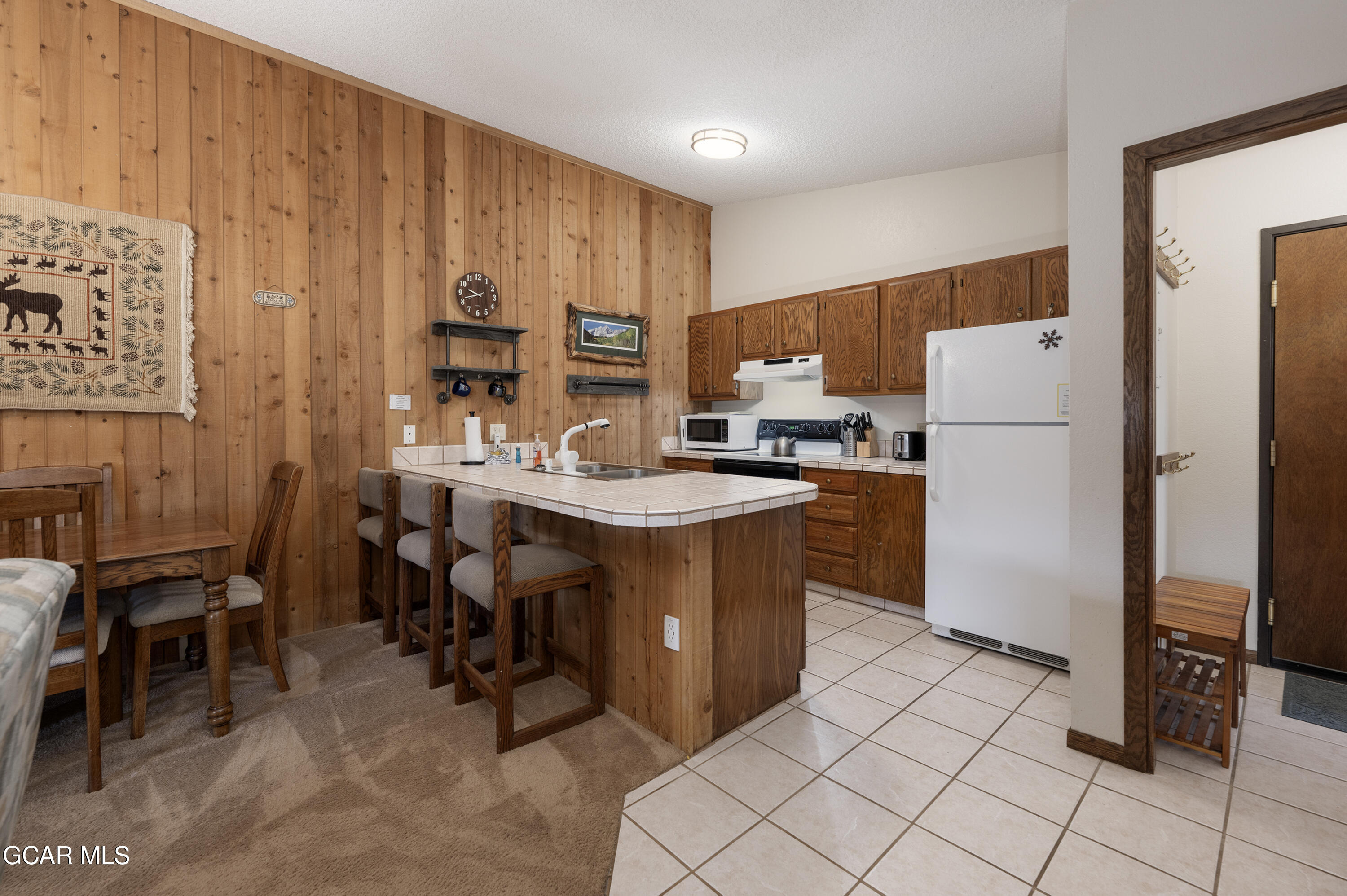 490 Kings Crossing Road, Unit 331 Winter Park, CO 80482 - Photo 5 of 38 a kitchen with refrigerator and cabinets
