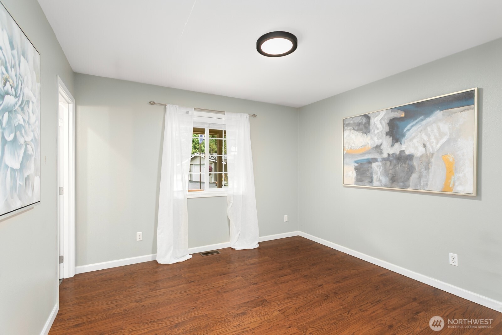 24020 Southeast 202nd Street Maple Valley, WA 98038 - Photo 20 of 39 an empty room with wooden floor and windows