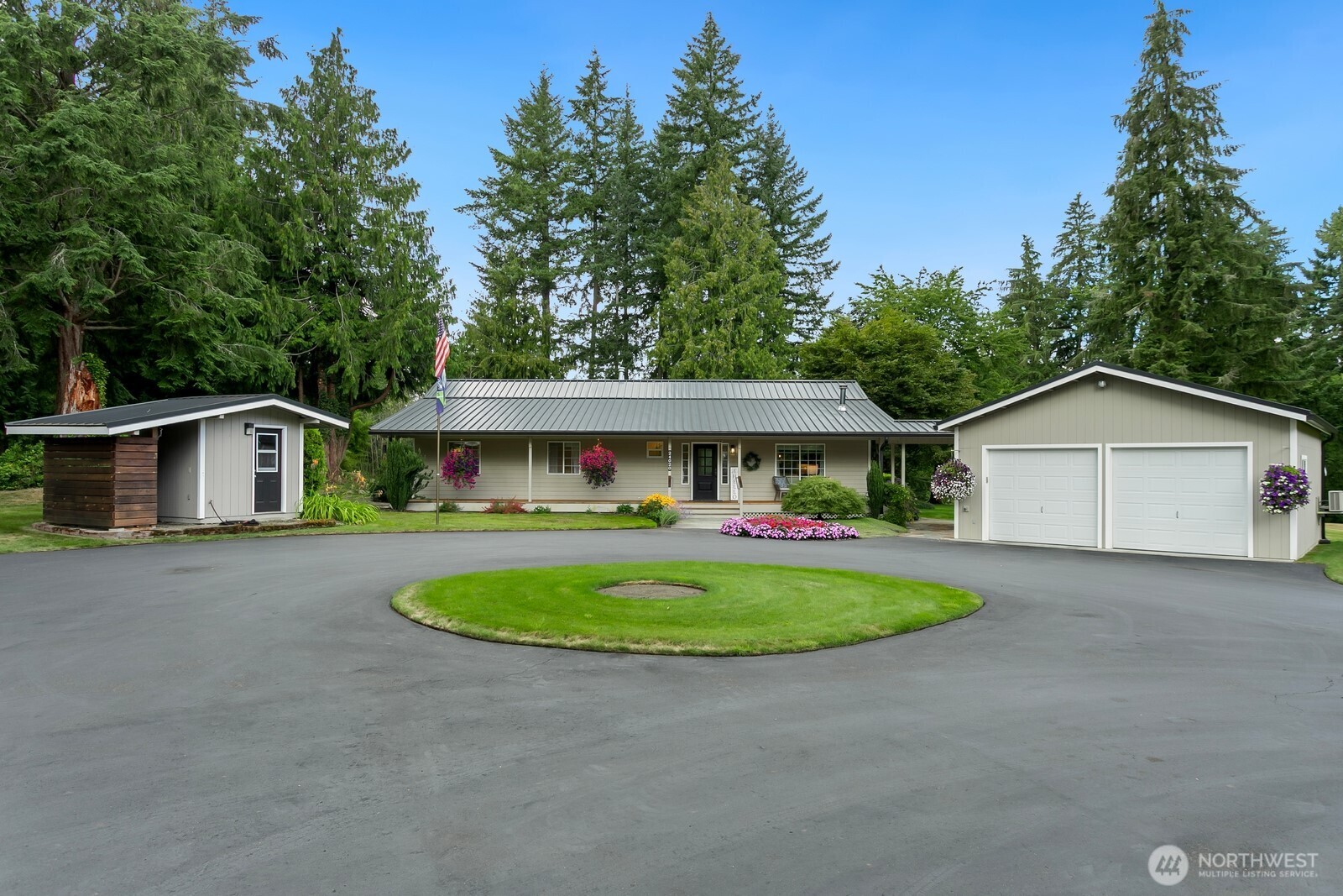 24020 Southeast 202nd Street Maple Valley, WA 98038 - Photo 2 of 39 a front view of a house with garden