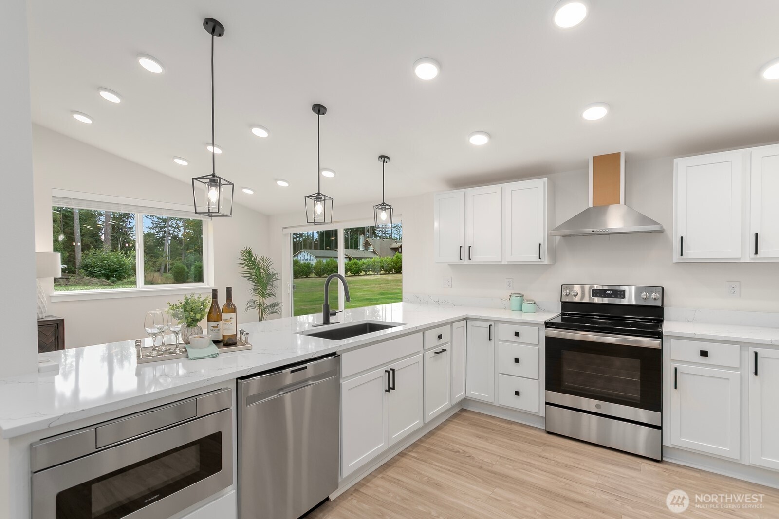 24020 Southeast 202nd Street Maple Valley, WA 98038 - Photo 27 of 39 a kitchen with a sink stove and cabinets