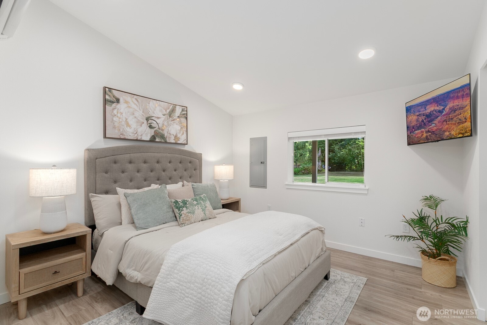 24020 Southeast 202nd Street Maple Valley, WA 98038 - Photo 30 of 39 a bedroom with a large bed and a potted plant