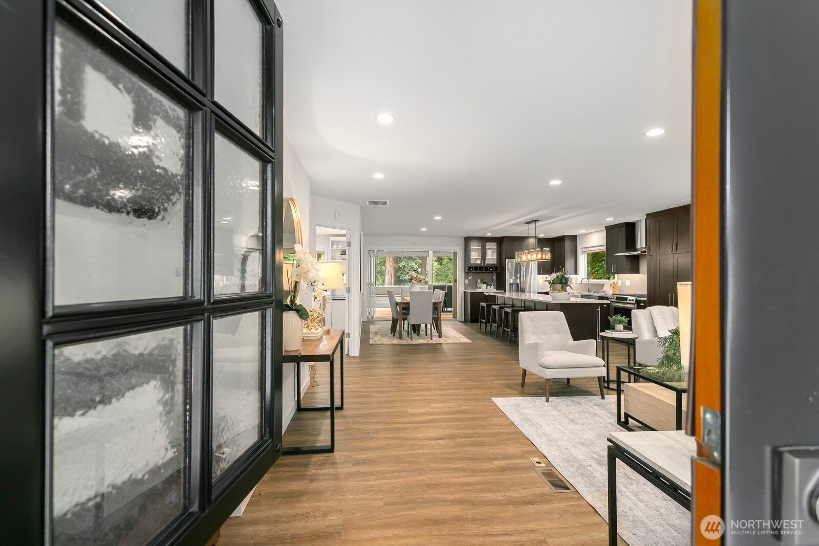 24020 Southeast 202nd Street Maple Valley, WA 98038 - Photo 5 of 39 a view of a living room and kitchen view with wooden floor