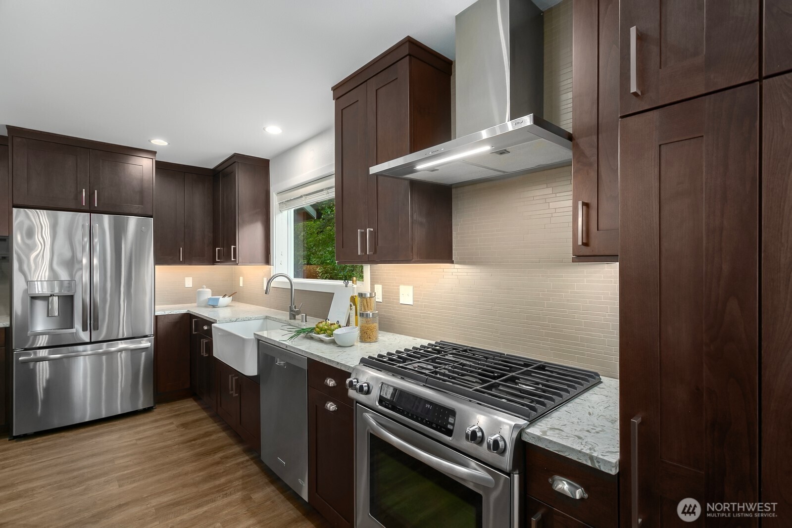 24020 Southeast 202nd Street Maple Valley, WA 98038 - Photo 8 of 39 a kitchen with stainless steel appliances granite countertop a stove refrigerator and microwave