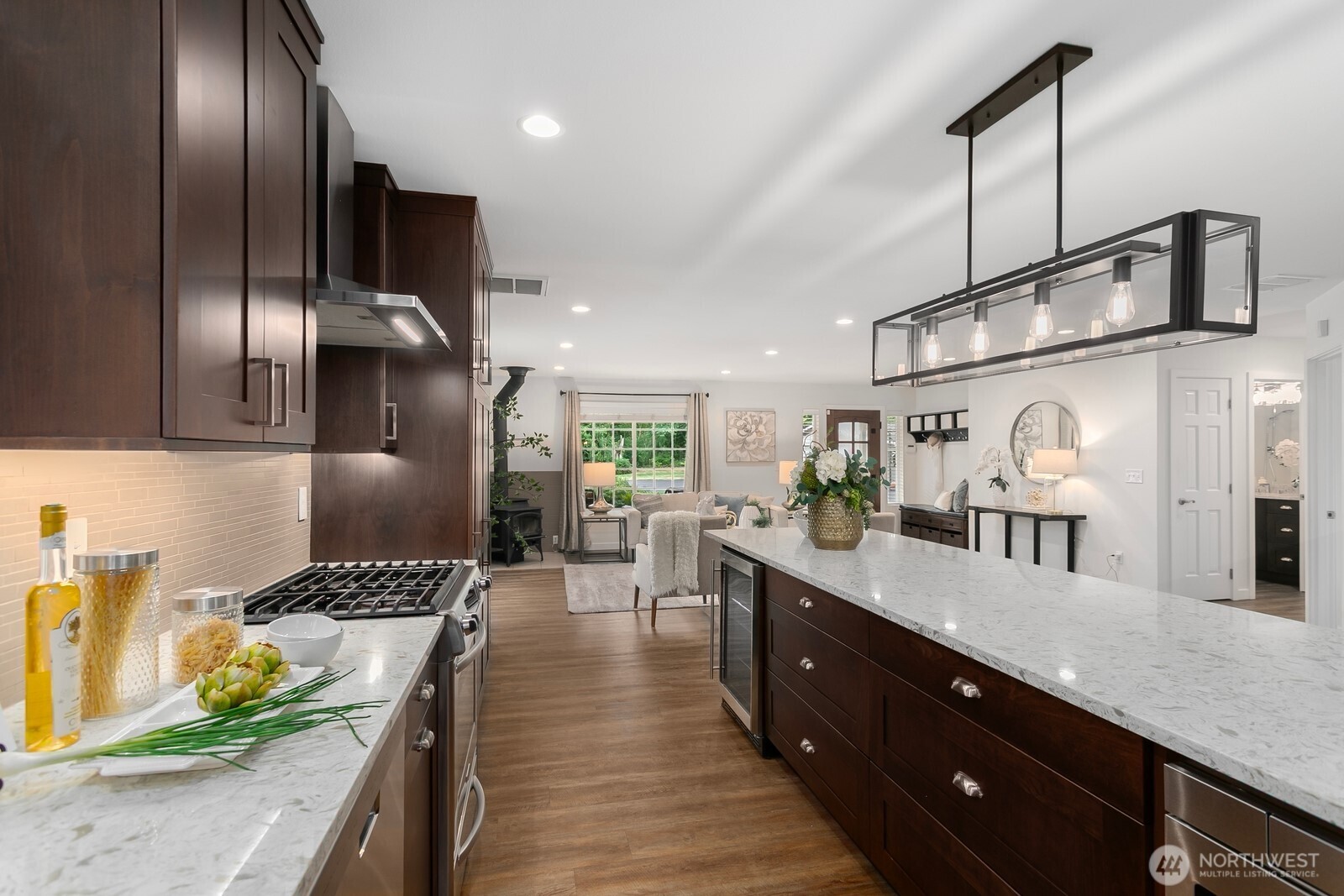 24020 Southeast 202nd Street Maple Valley, WA 98038 - Photo 9 of 39 a large kitchen with stainless steel appliances kitchen island granite countertop a large counter top and sink