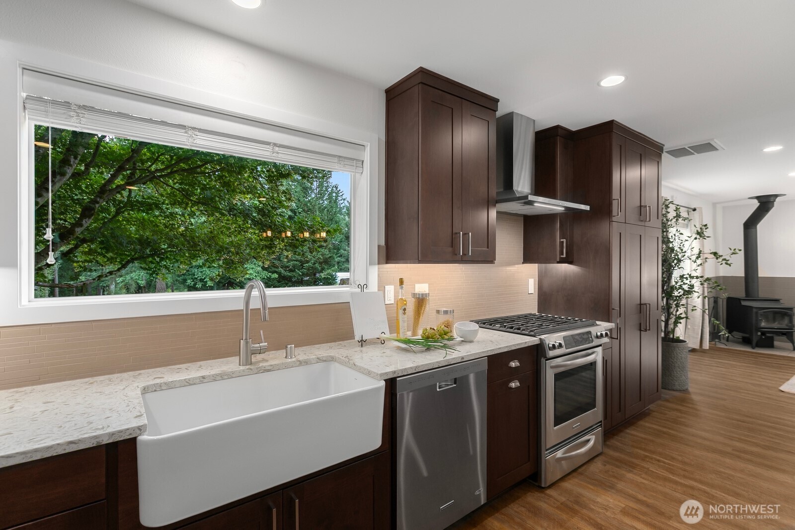 24020 Southeast 202nd Street Maple Valley, WA 98038 - Photo 10 of 39 a kitchen with kitchen island granite countertop a sink stainless steel appliances and counter space
