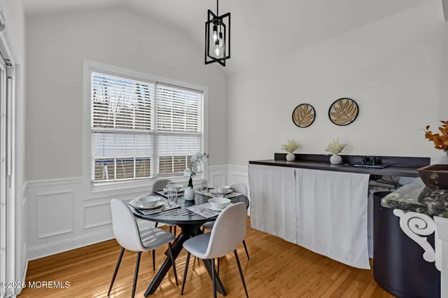 a view of a dining room with furniture and window