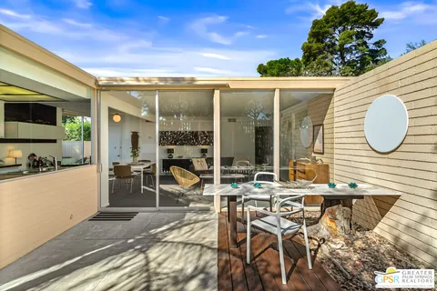 a bedroom with furniture and mirror
