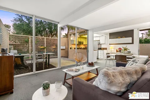 a view of a dining room with furniture and a potted plant