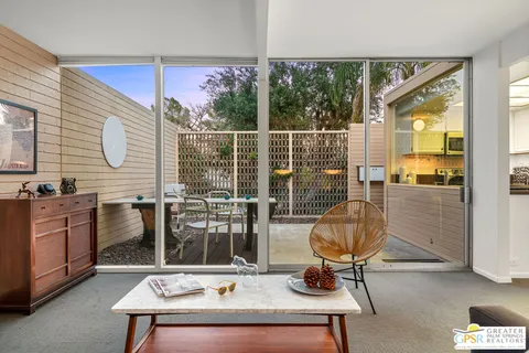 a backyard of a house with table and chairs