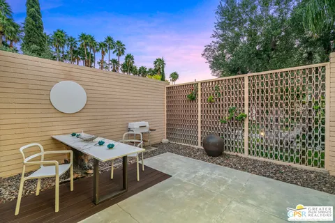 a view of backyard with a table and chairs