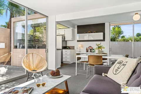 a living room with furniture and a floor to ceiling window