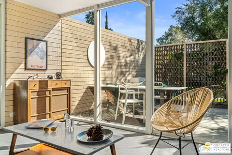 a view of a balcony with chair and wooden floor