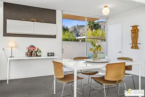 a view of dining room with a table and chairs