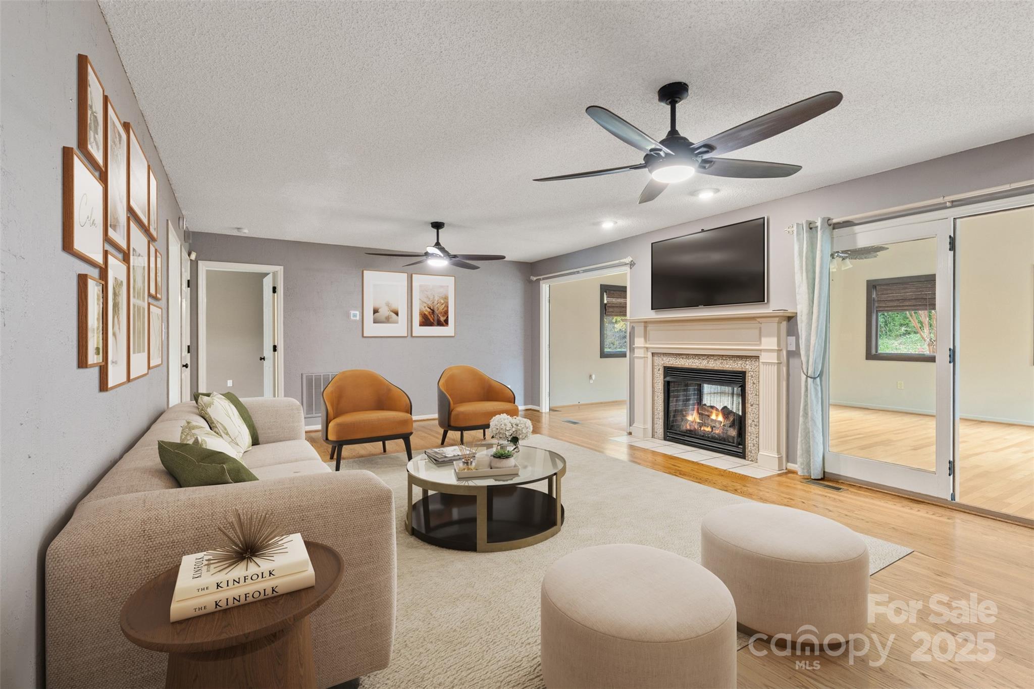 3233 6th Avenue Northeast Conover, NC 28613 - Photo 11 of 30 a living room with furniture a fireplace and a flat screen tv