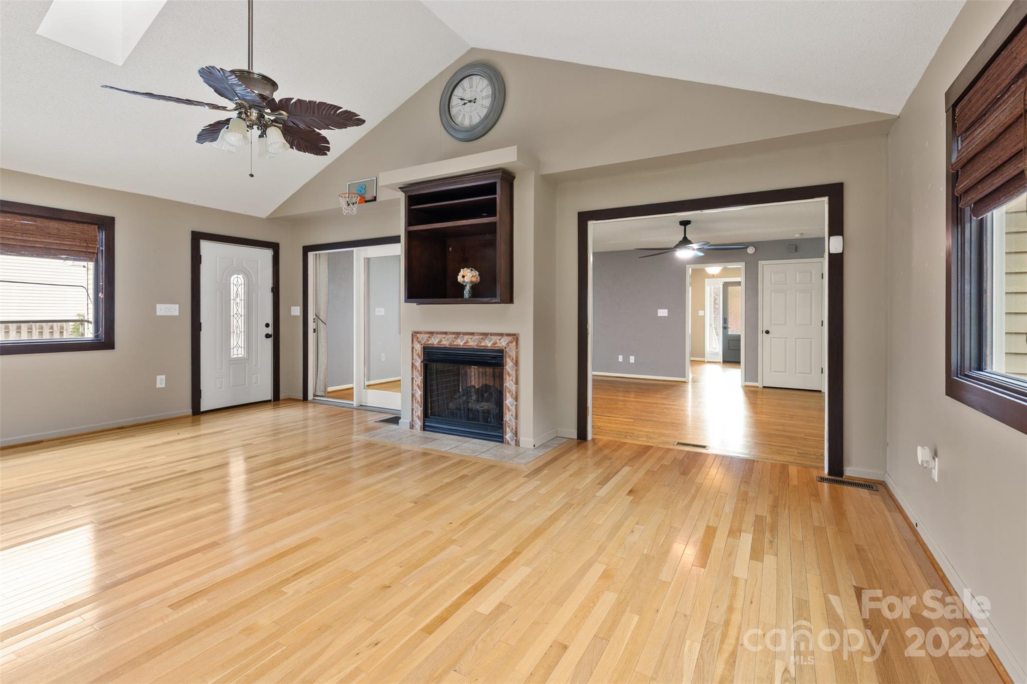 3233 6th Avenue Northeast Conover, NC 28613 - Photo 12 of 30 a view of an empty room with wooden floor and a fireplace