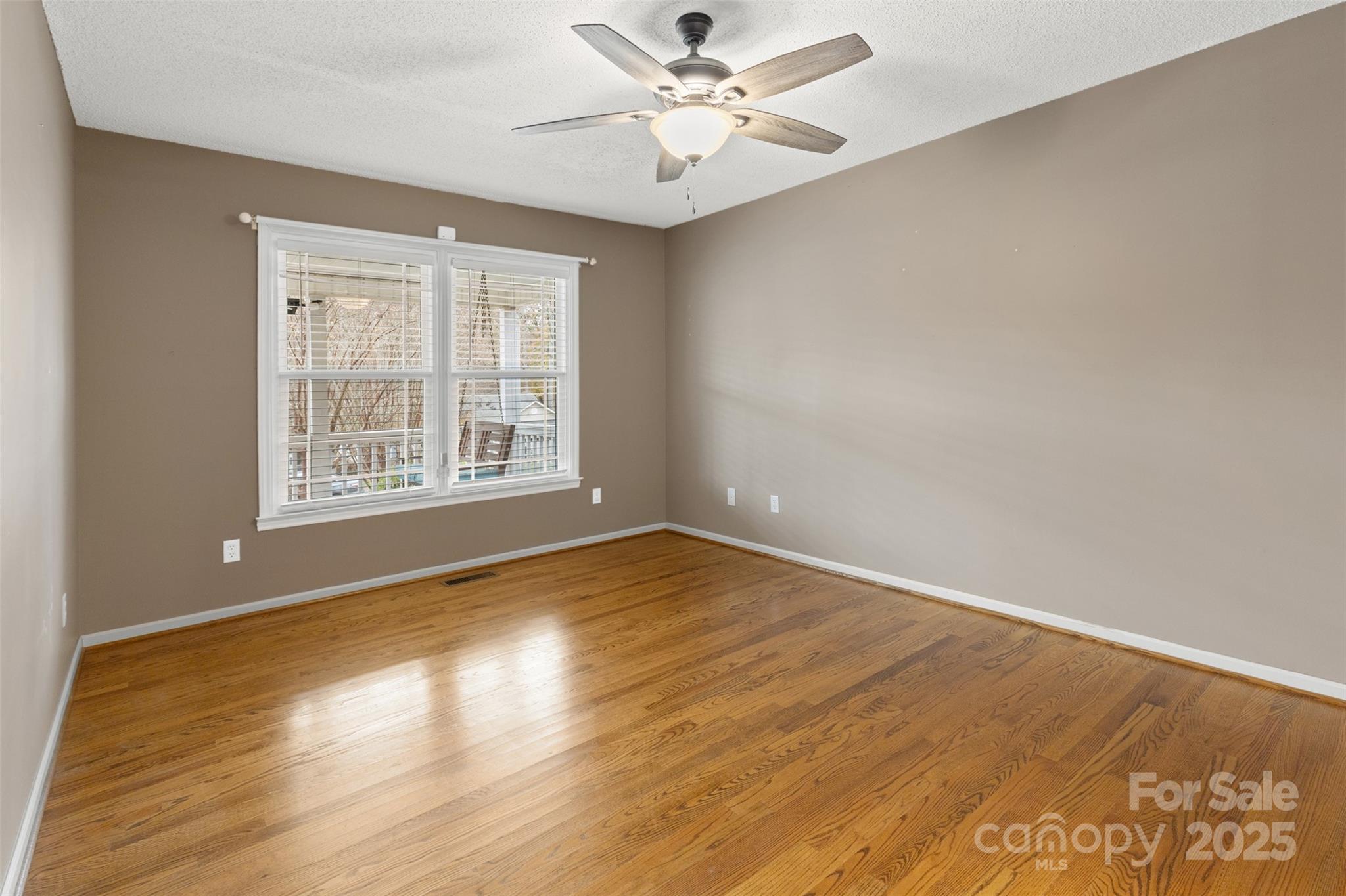 3233 6th Avenue Northeast Conover, NC 28613 - Photo 14 of 30 an empty room with wooden floor and windows