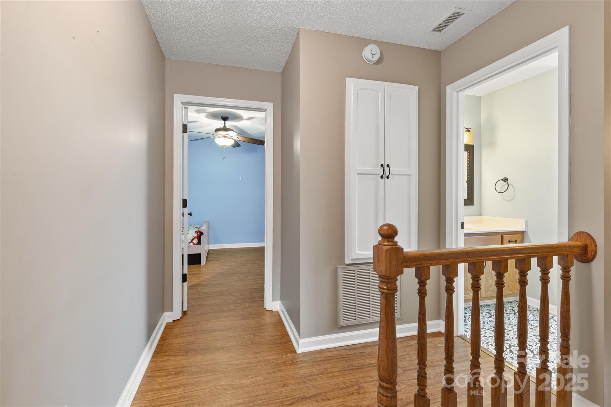 3233 6th Avenue Northeast Conover, NC 28613 - Photo 19 of 30 a view of a hallway with wooden floor and a bathroom